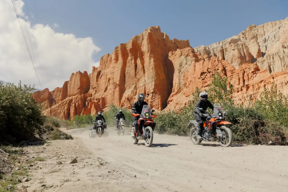 Guided convoy riding through the red rock canyons of Upper Mustang
