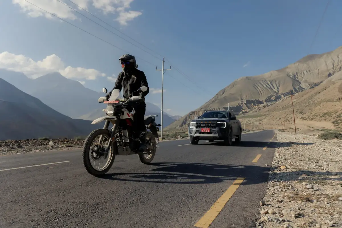 Rider and 4x4 support vehicle on the road in Lower Mustang